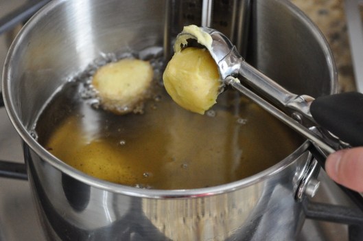 Dropping zeppole batter into hot fat