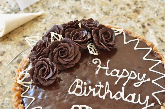 Arrange white chocolate leaves among roses