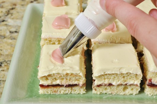 Piping rosebuds on the petit fours